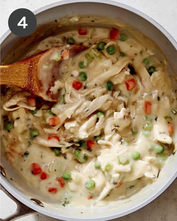 Chicken pot pie filling in a pot simmering.