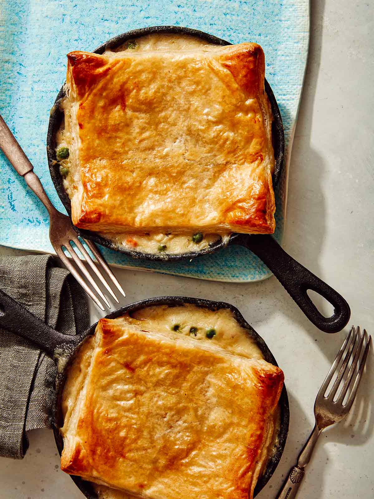 Freshly baked chicken pot pies in skillets.
