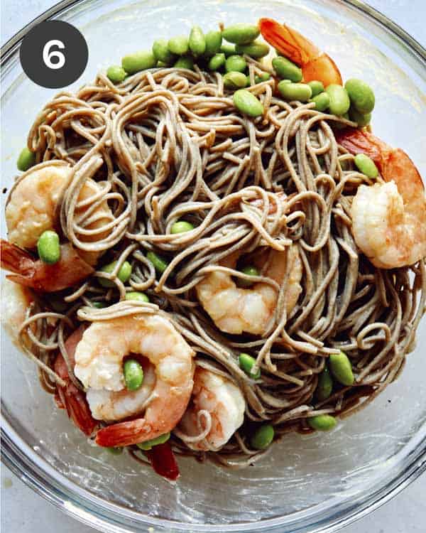 Soba noodles with shrimp in a glass bowl.